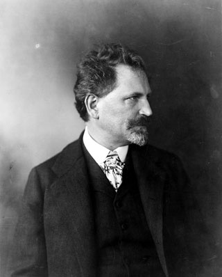 black and white photo of artist Alfons Mucha in profile
