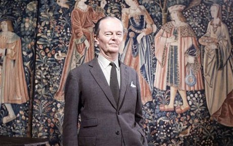 photo of English gentleman standing before old tapestry, Sir Kenneth Clark