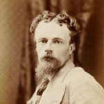 young male victorian with beard turning to camera